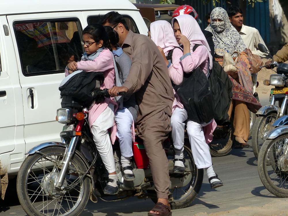School girls being picked up next door to the Bunyaad office. Dad plus 4 girls heading into rush hour traffic!