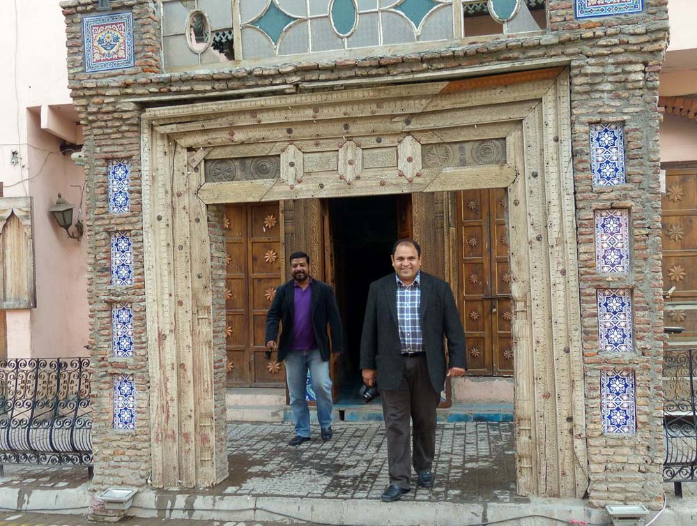 Afaq and Yousaf walking through a gateway at the entrance to a Haveli (large house or mansion from the Mughal age) just outside the old city wall. 