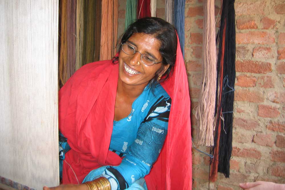 female rug knotter at her loom