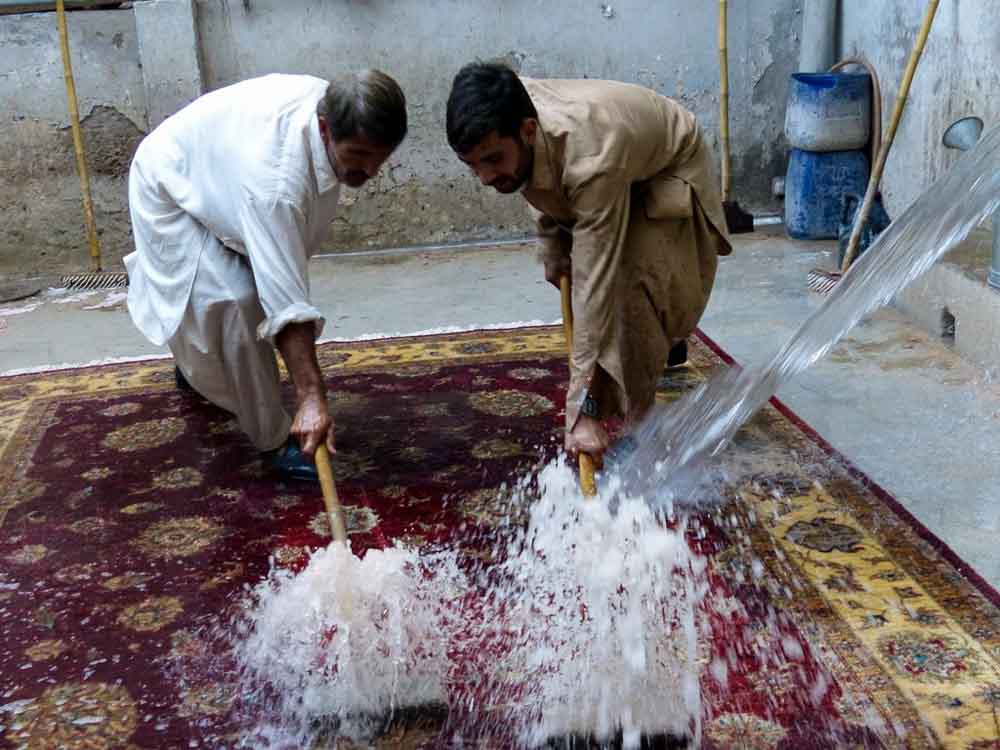 Washing a Bunyaad Chobi rug at Wajid's rug washing facility