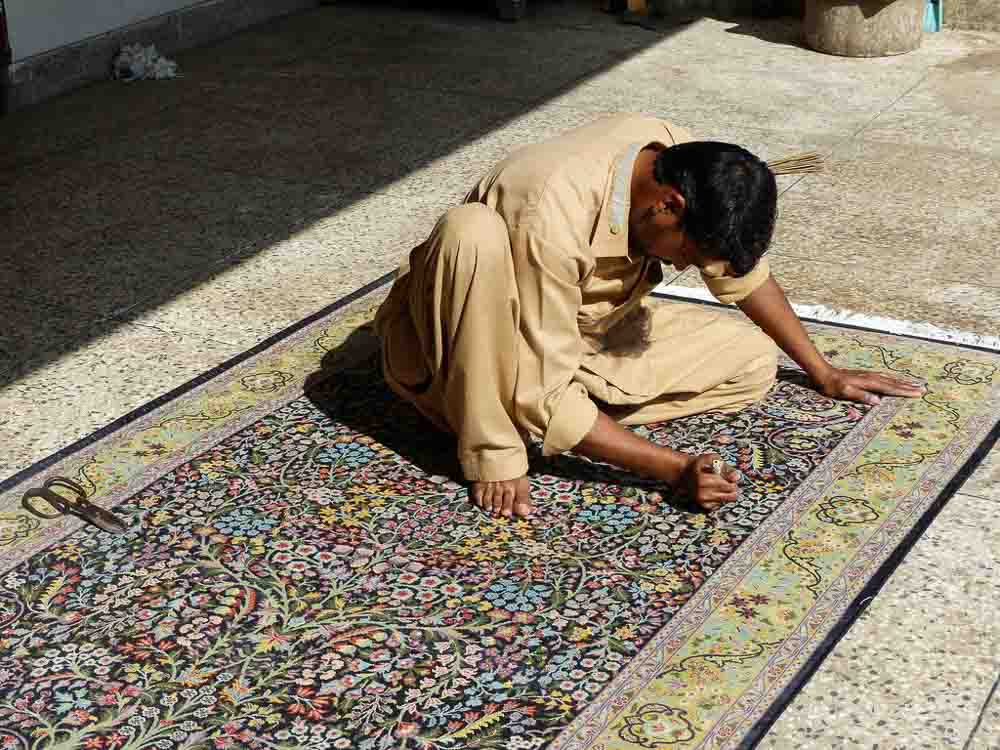 Imran working on final small details of a 4 x 6 foot tree of life Persian rug.