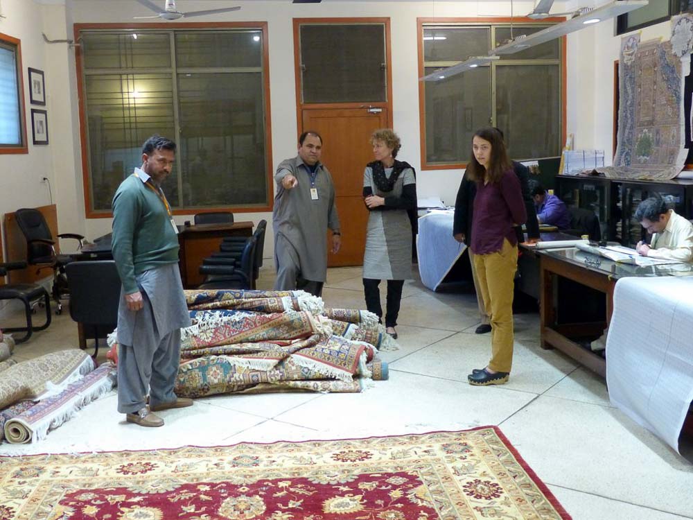 Yousaf is explaining the rug making process to Christine and Elise of WFTO Asia. 